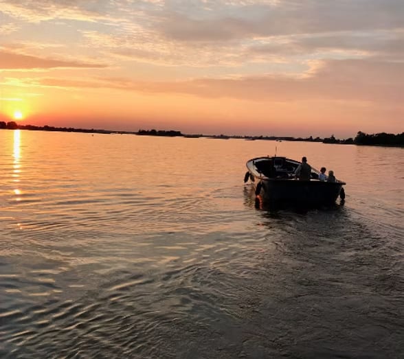 Green Marine boat at sunset